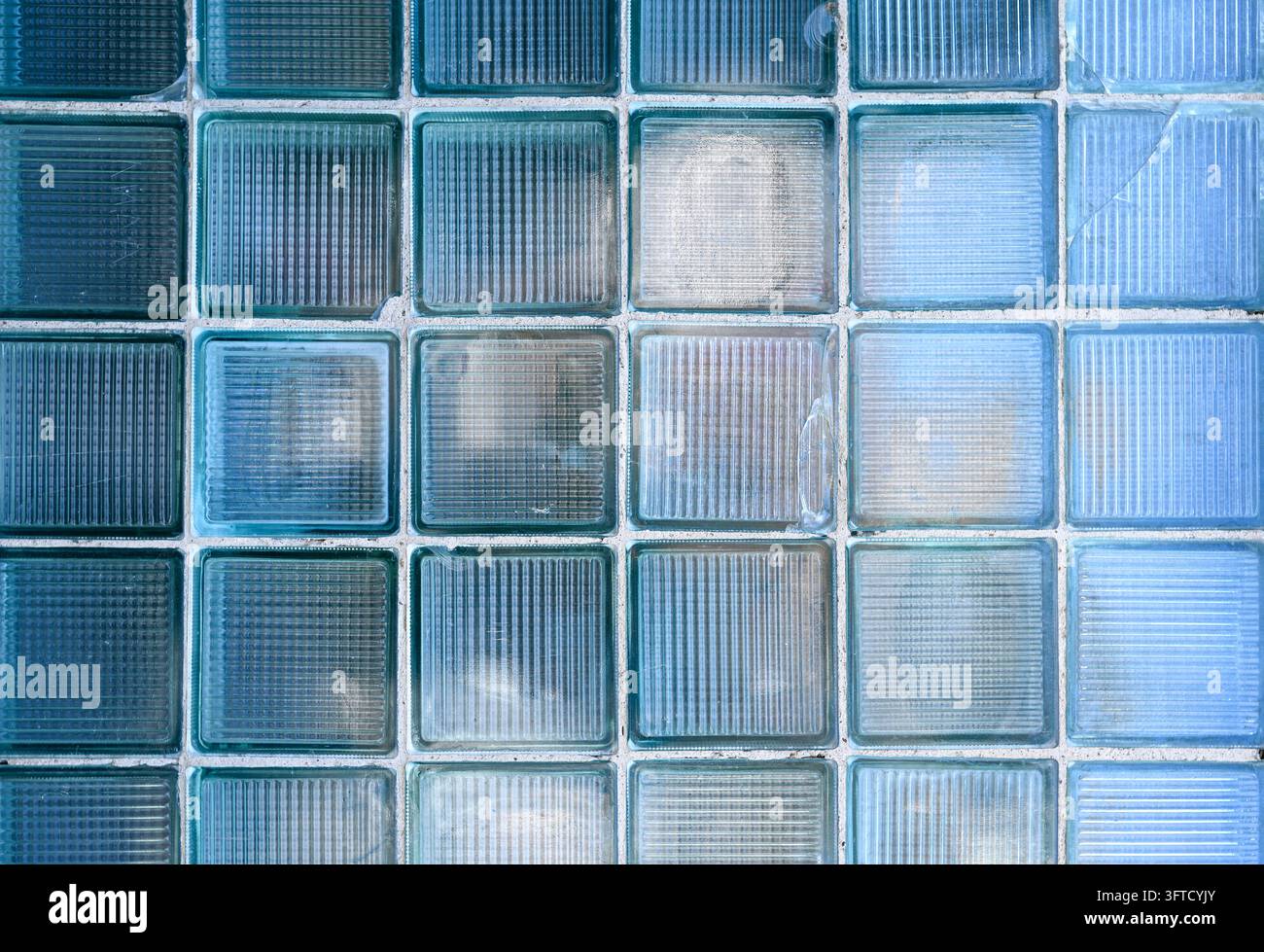 Wand mit Reihen aus alten beschädigten Glasziegeln oder Blöcken als Textur oder Hintergrund Stockfoto