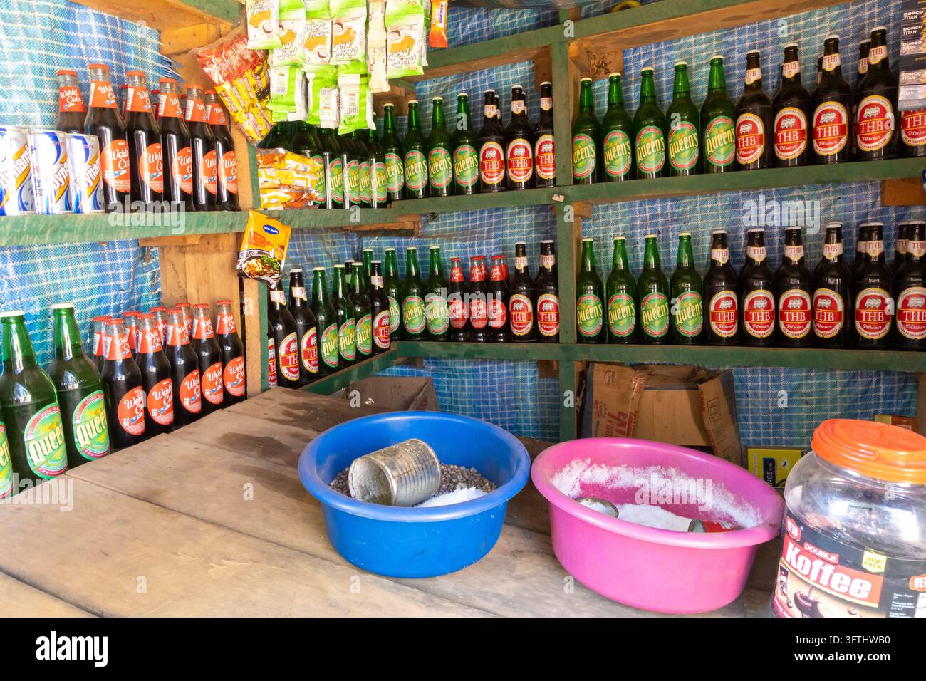 Holzregale eines kleinen Ladens, gestockt mit Bierflaschen, Softgetränken und Snacks, Menabe, Tsiribihina, Madagaskar Stockfoto