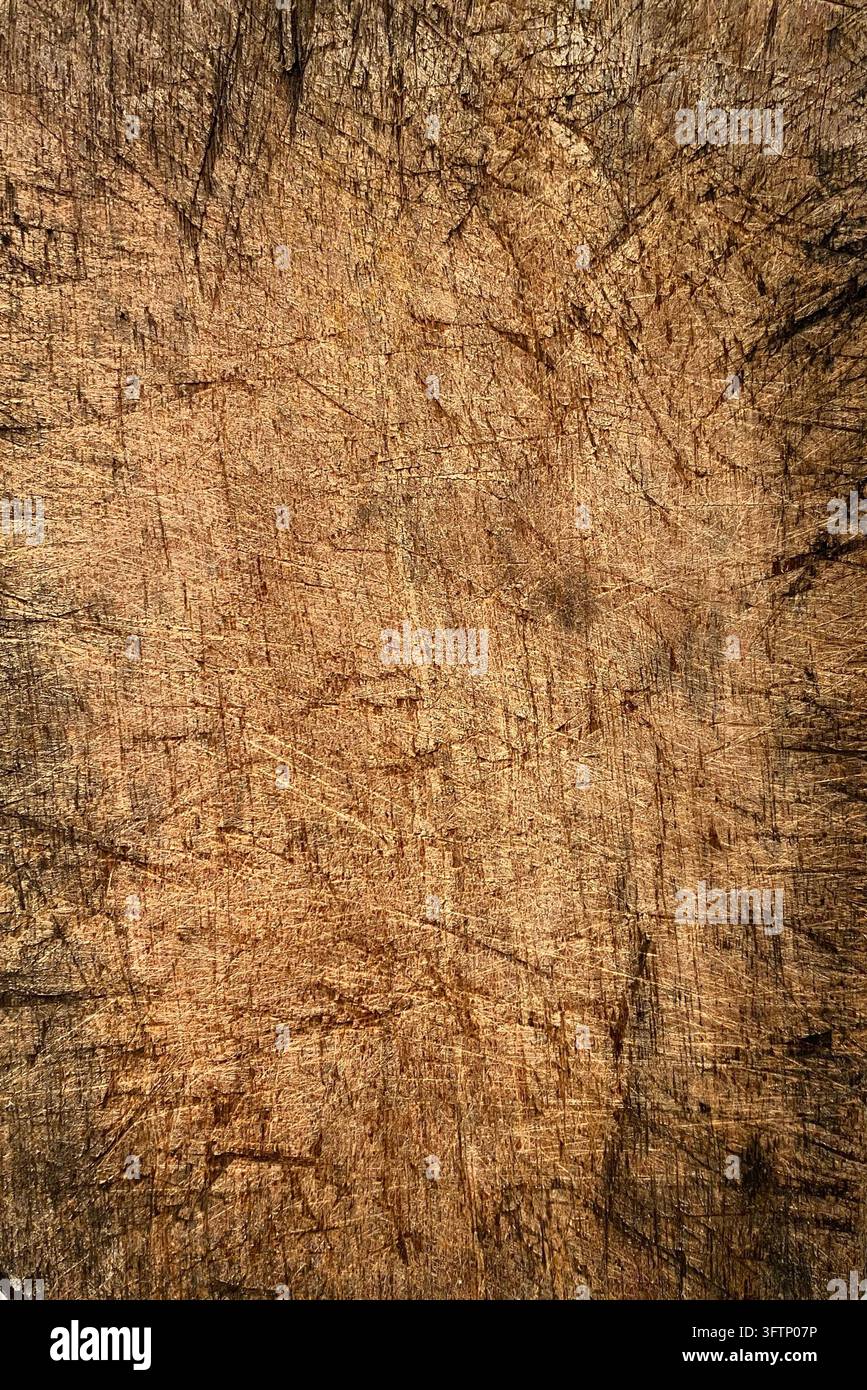 Oberansicht eines alten abgenutzten Holzschneidebretts mit Messerkratzern auf weißer Oberfläche, Vintage-Küchenschneidebrett - Smartphone-aufgenommenes Stockfoto