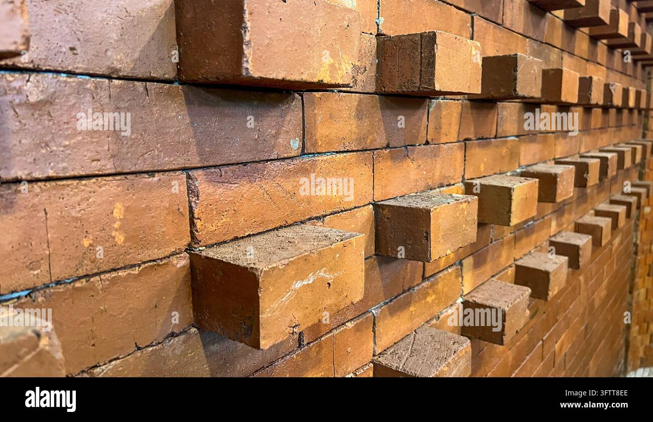 Roter und orangefarbener Ziegelwandtextur mit Laufender-Bindung-Maurermuster Stockfoto