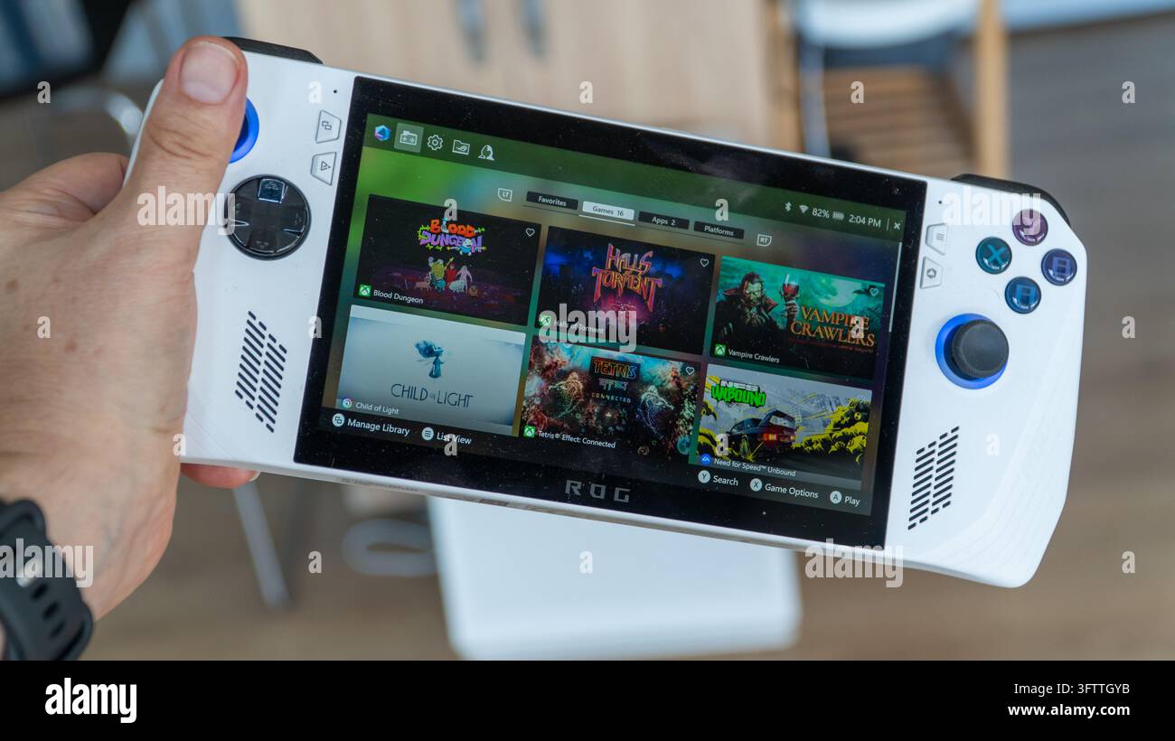 Türkei – 7. Oktober 2026: Hand, die einen weißen Asus ROG Ally Handheld-Gaming-PC hält, dessen Bildschirm eine Spielebibliothek wie Halls of Torment und Vam anzeigt Stockfoto