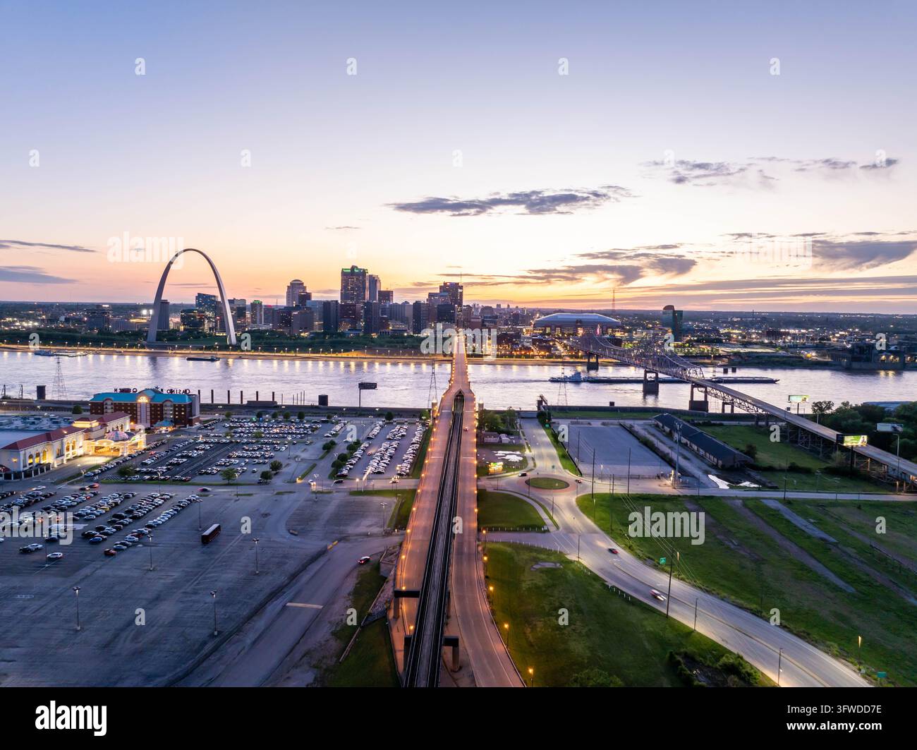 Luftaufnahme der beleuchteten Skyline von St. Louis, Missouri im Abenddämmerung, zeigt den ikonischen Gateway Arch, den Mississippi und die Eads-Brücke, die eine Stockfoto