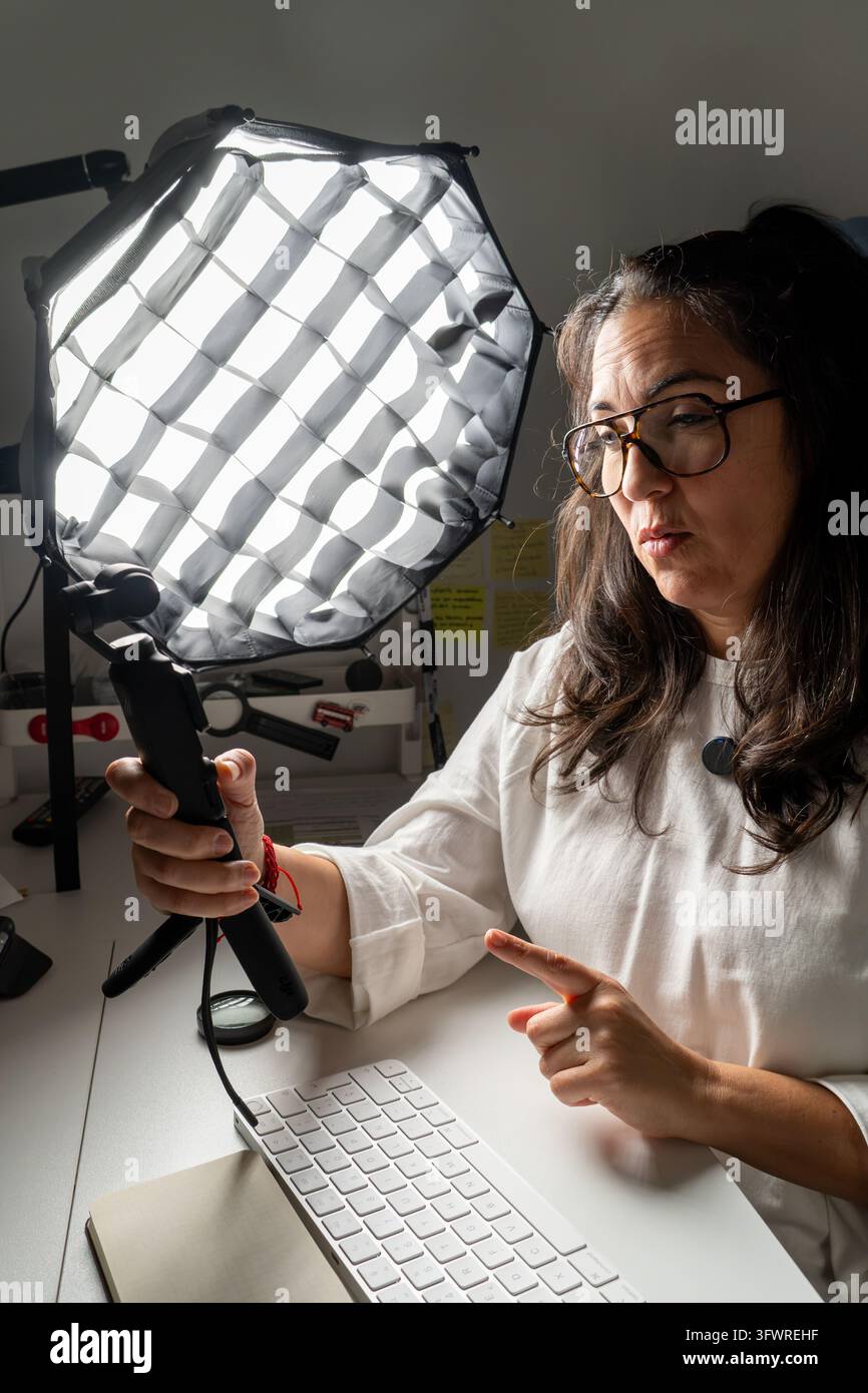 Frau erstellt Videoinhalte mit Beleuchtungsaufbau Stockfoto