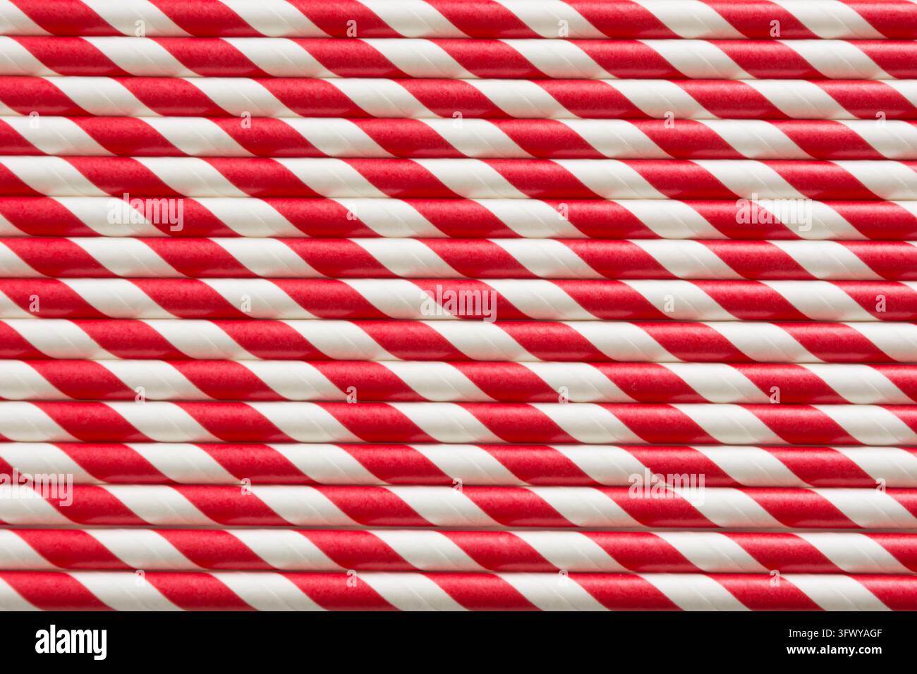 Weihnachtsrote Strohhalme als Hintergrund. Oberblick. Muster. Stockfoto