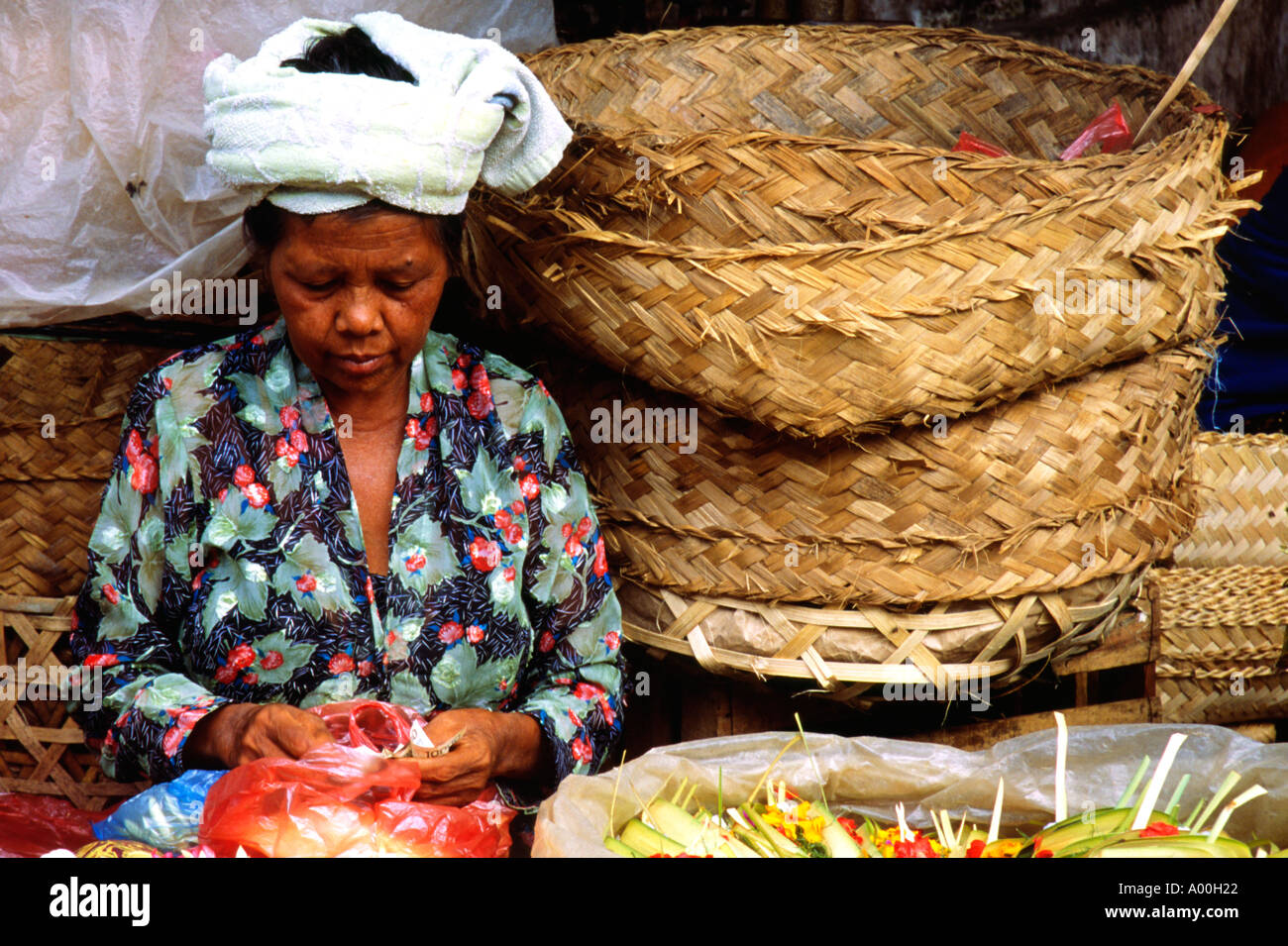 einheimische Frau zählen ihre Einnahmen an ihrem Blume Stand in Denpasar Bali Indonesien vermarkten Stockfoto