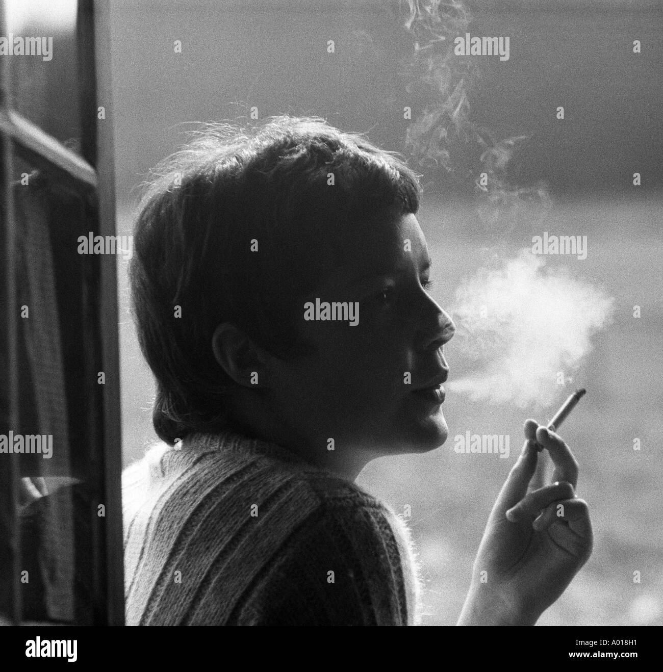 Gesundheit, junges Mädchen, junge Frau raucht eine Zigarette, Rauch, wieder Licht, b&w, schwarz / weiß, schwarze & weiß Fotografie Stockfoto