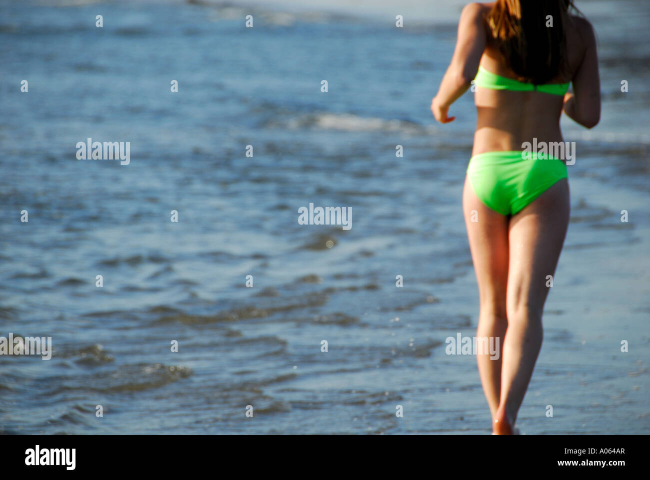 Teenager-Mädchen läuft am Strand Stockfoto