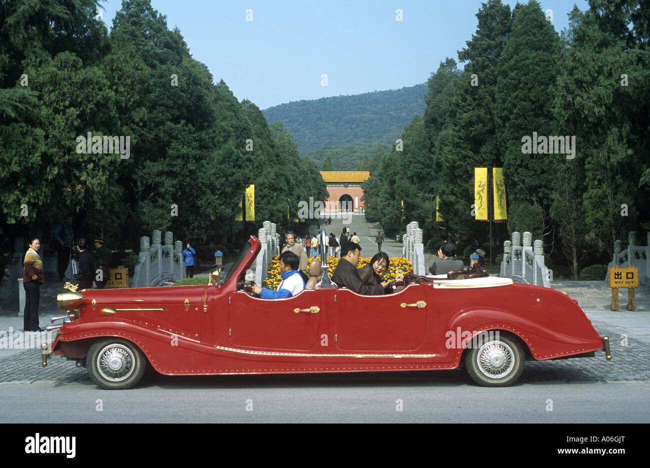 Leute sitzen in einem großen glänzenden roten Oldtimer verwendet für VIPs bei Ming Xiaoling oder Grab des Hongwu auf Zijin Shan in Nanjing Stockfoto