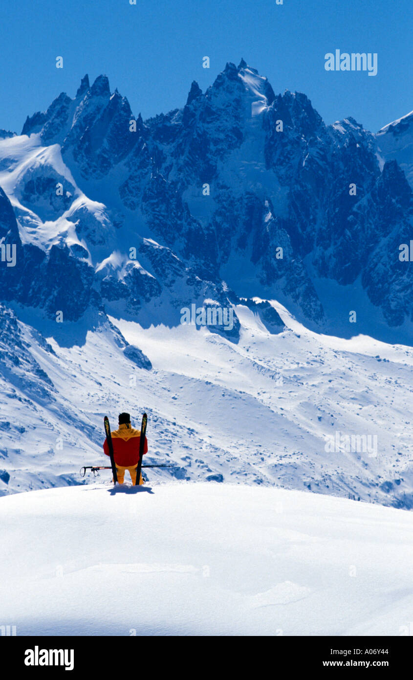 Skifahrer, die sitzen auf seinen Skiern genießen den Blick auf den französischen Bergen des Mont Blanc Massivs in Frankreich Europa Stockfoto
