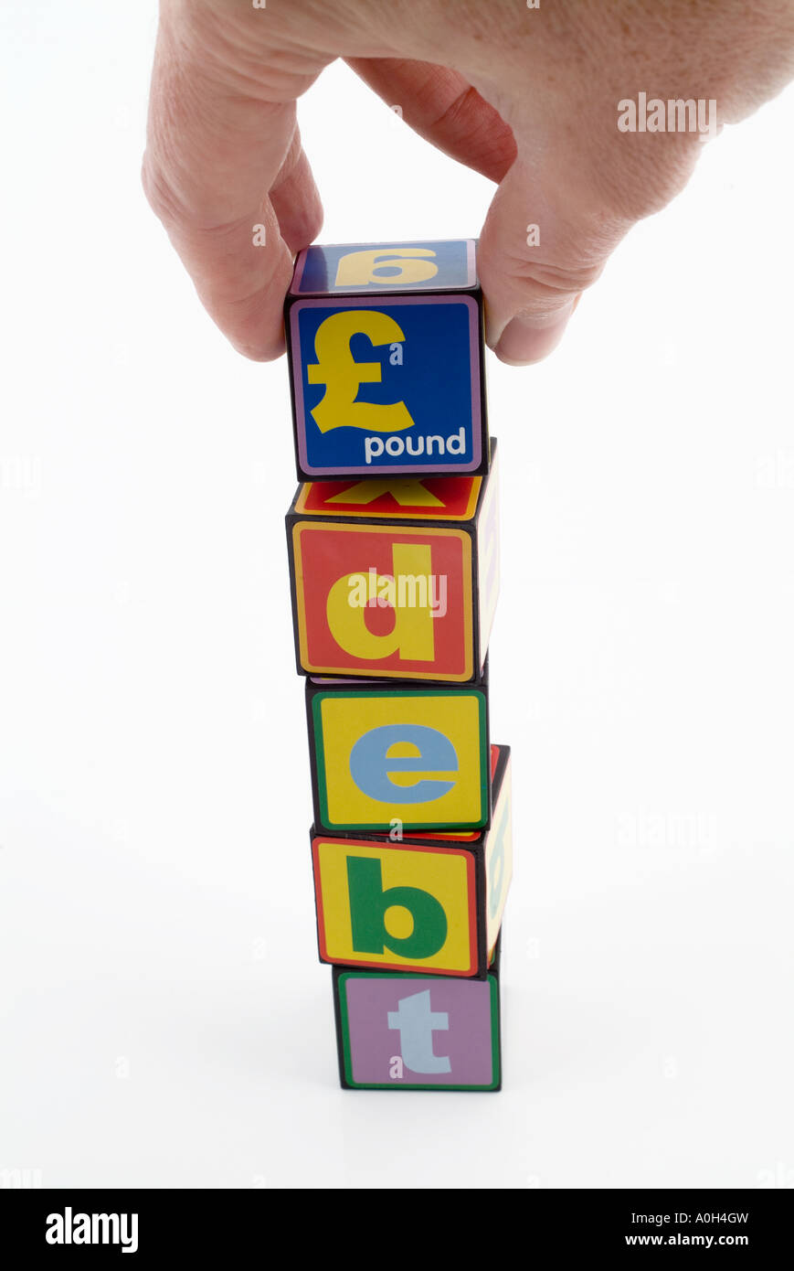 Spielzeug Bausteine mit dem Wort Schulden und das Pfund symbol Stockfoto