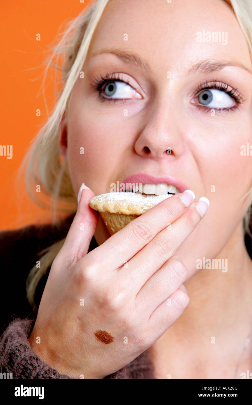 Junge Frau Essen Mince Pie Modell veröffentlicht Stockfoto