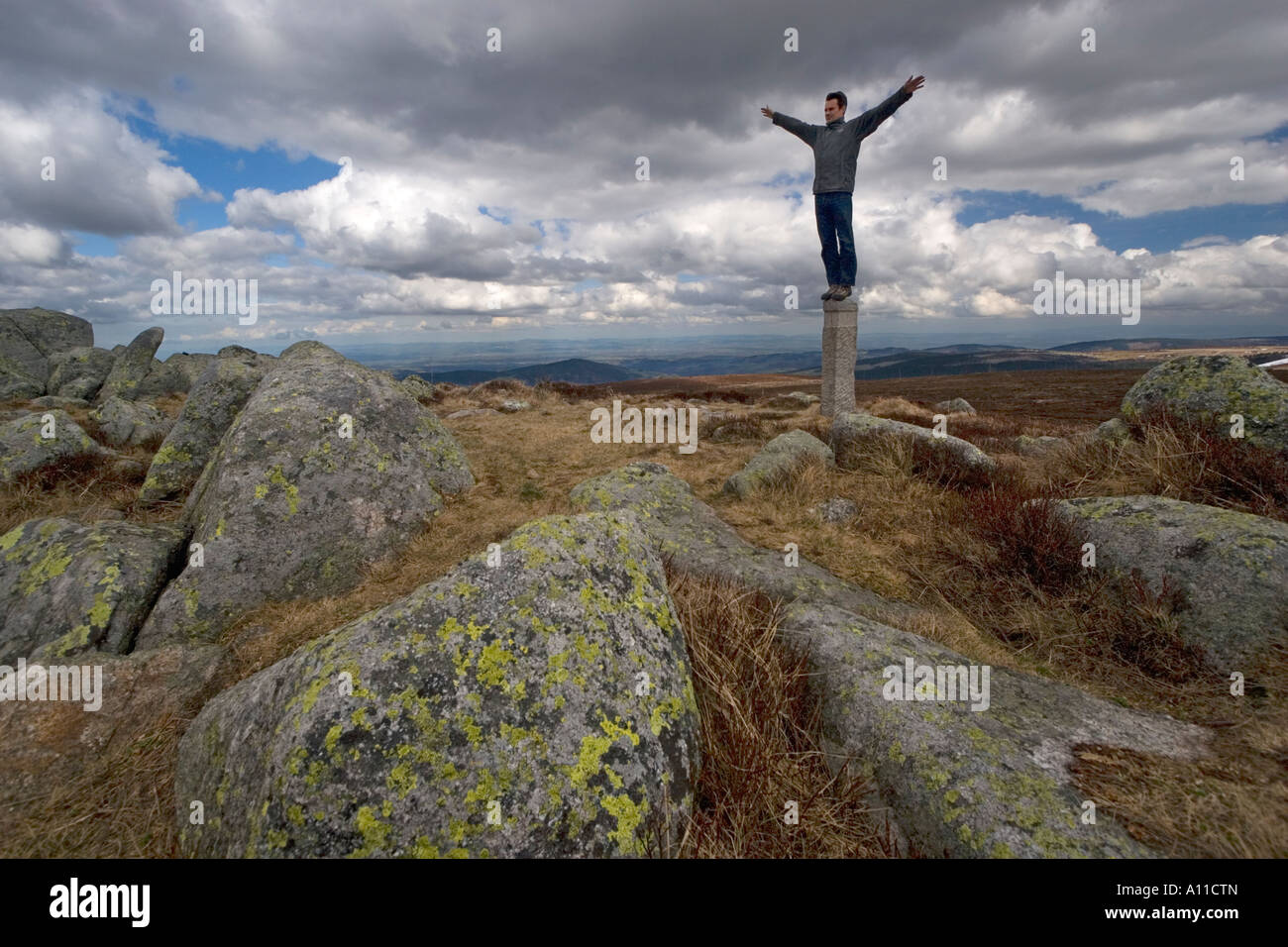 Mann seinen Gleichgewichtssinn auf einem Granit-Grenzstein (Frankreich) testen. Homme En Équilibre Sur Une de Granit (Frankreich) zu tragen. Stockfoto