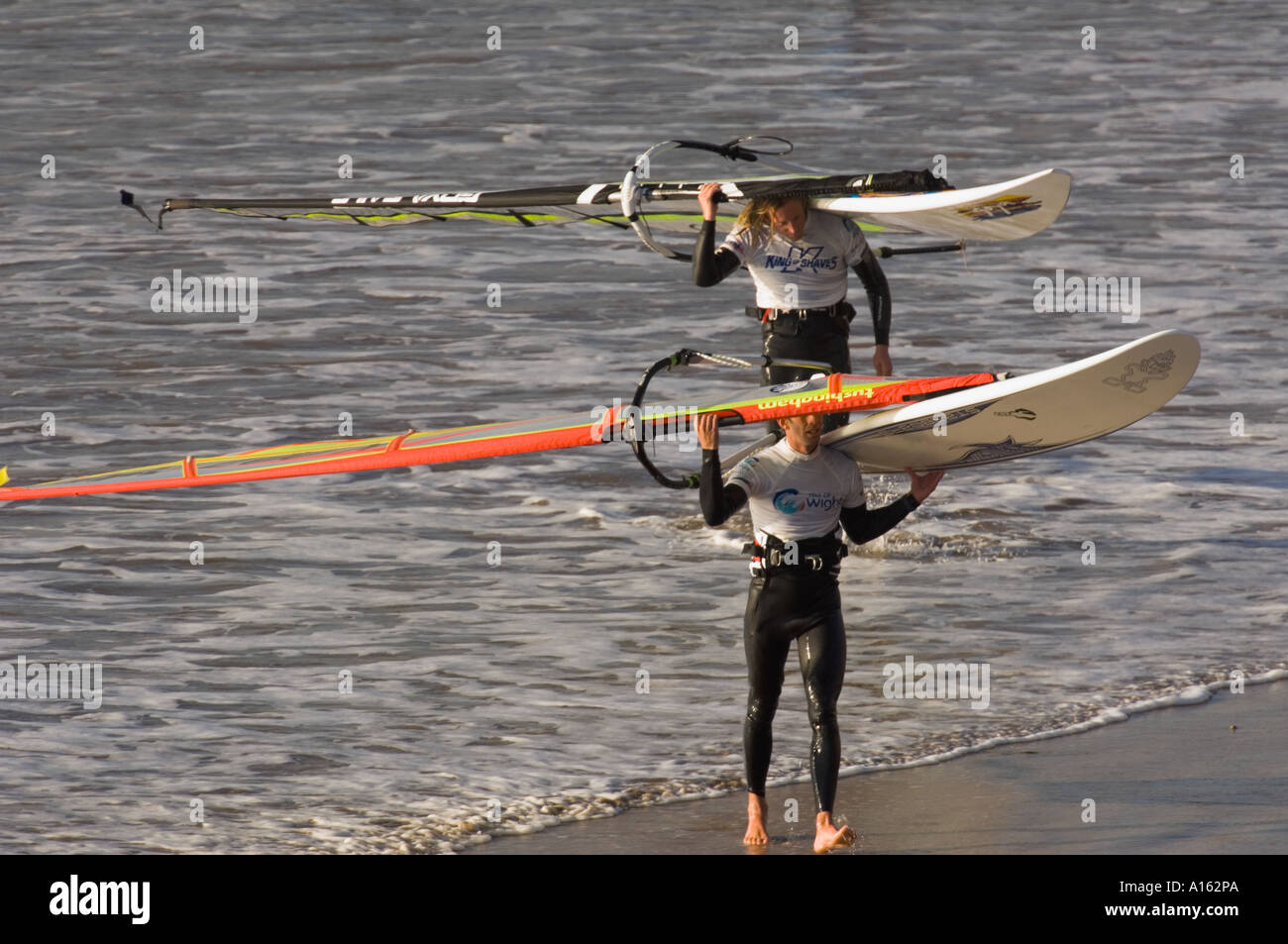 Oktober 2005-Windsurfer White Air Extreme Sports Festival Isle Of Wight verlassen das Wasser tragen ihre Boards und Segel Stockfoto