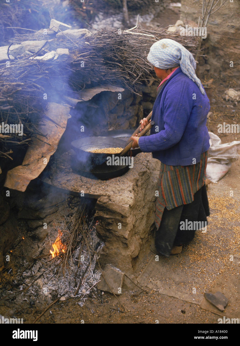 Eine Frau, die bereit für die Herstellung von Tsampa am Nylam in Tibet Asien N Blythe Gerste rösten Stockfoto