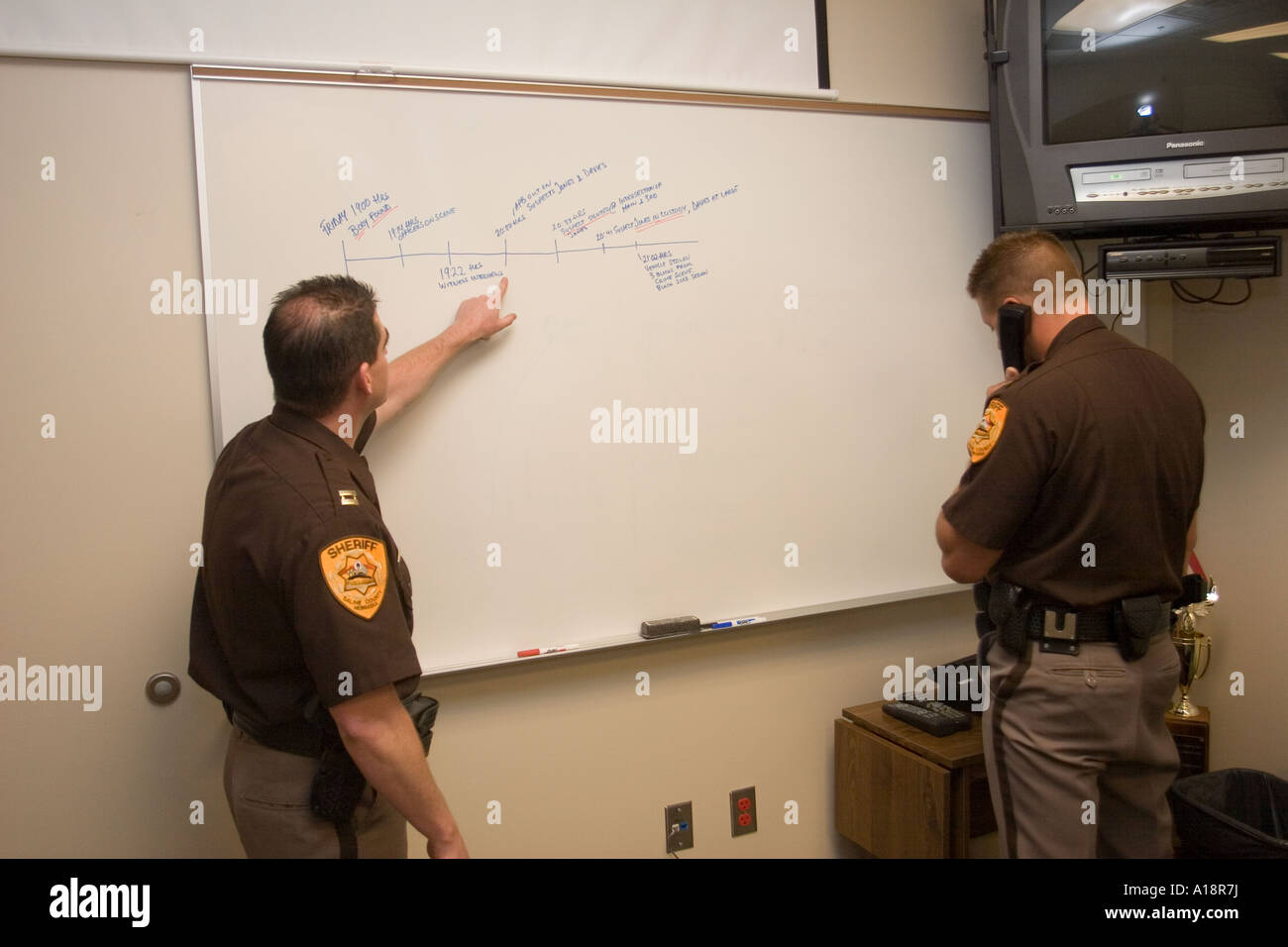 Ermittler Kapitäne Mulbery und Kalkwarf mit der Saline County Sheriff s Büro eine Zeitleiste zu studieren. Stockfoto