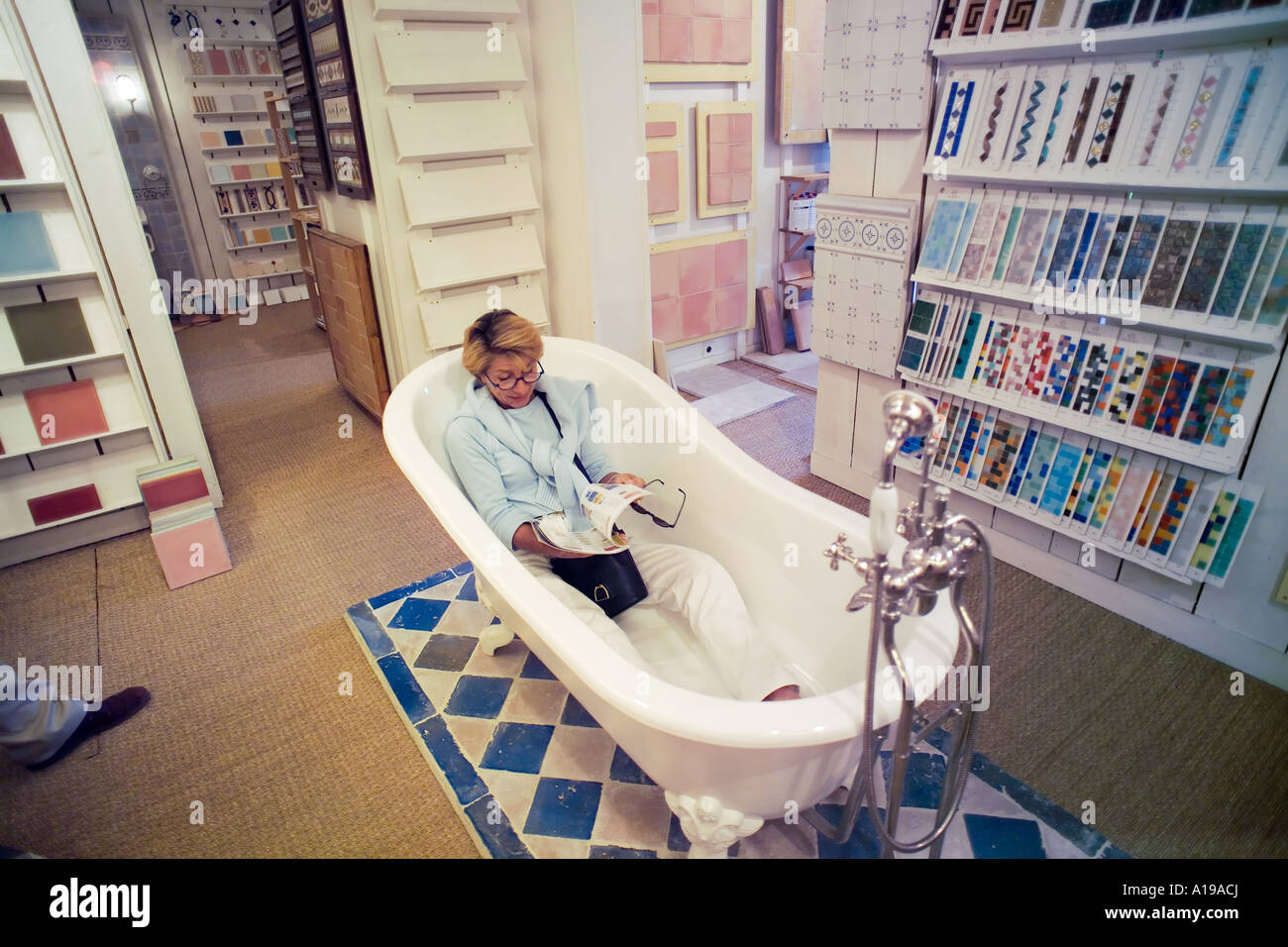 Frau in der Wanne sitzen gekleidet, surfen Badezimmer Ausstattung Katalog, Showroom, Frankreich, Europa Stockfoto