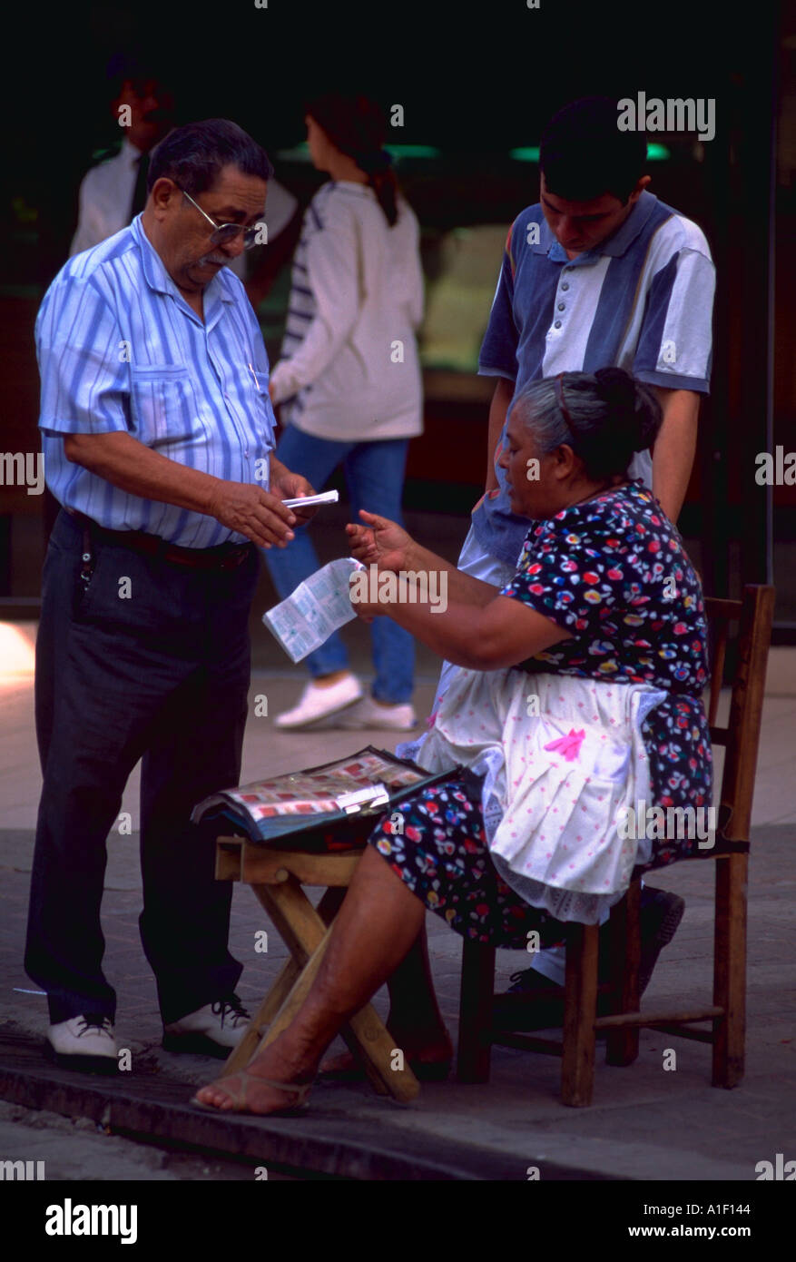 Mann von Frau auf der Straße in Peatonal Mall in Tegucigalpa, Honduras Lotterielos kaufen Stockfoto