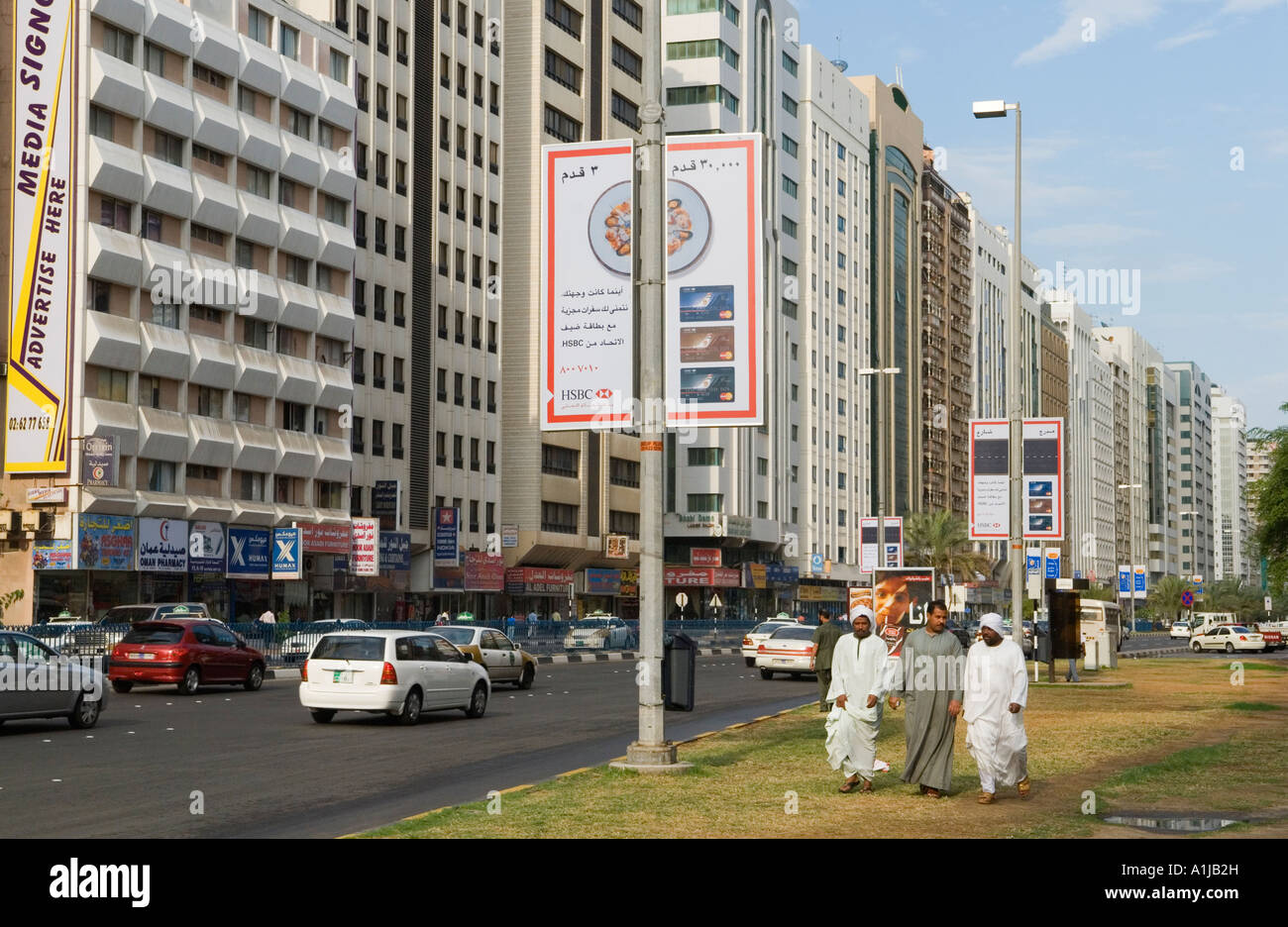 Abu Dhabi Vereinigte Arabische Emirate VAE drei arabischen Männern gehen Sie Stadtzentrum Straße HOMER SYKES Stockfoto
