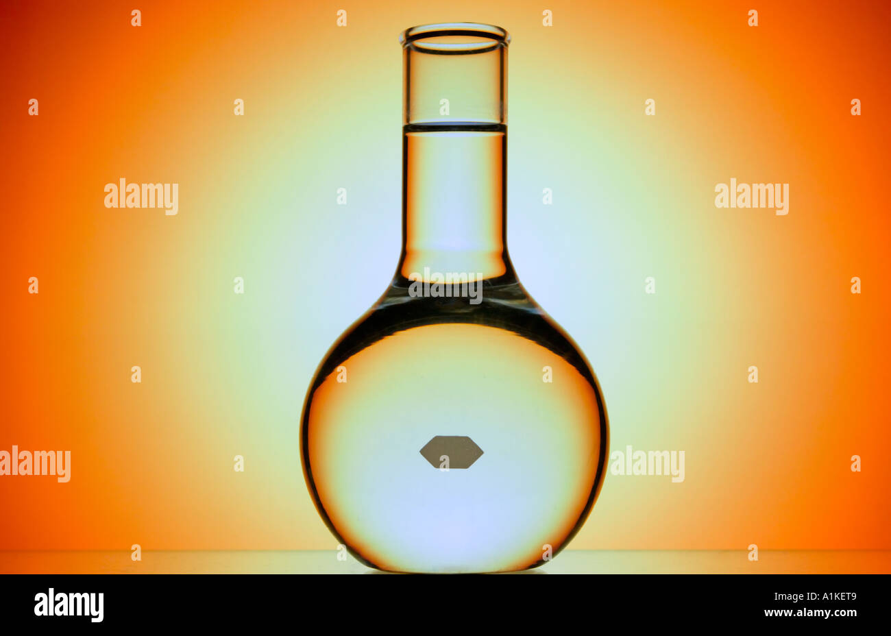 Becher mit Flüssigkeit vor prismatischen Farben Stockfoto