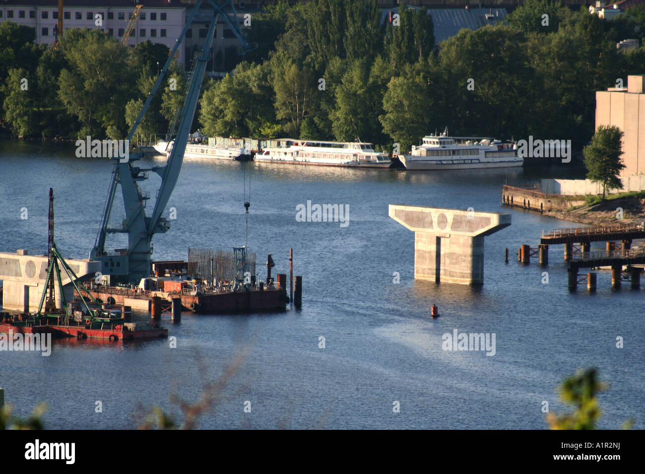 Brückenbau am Fluss Dnipro in Kiew mit Kränen und Schiffen im Hintergrund. Stockfoto