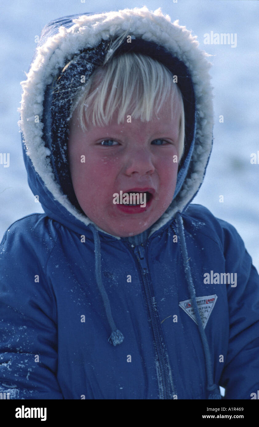 kleiner Junge in warme Winterkleidung im Schnee Herr Einfrieren Stockfoto