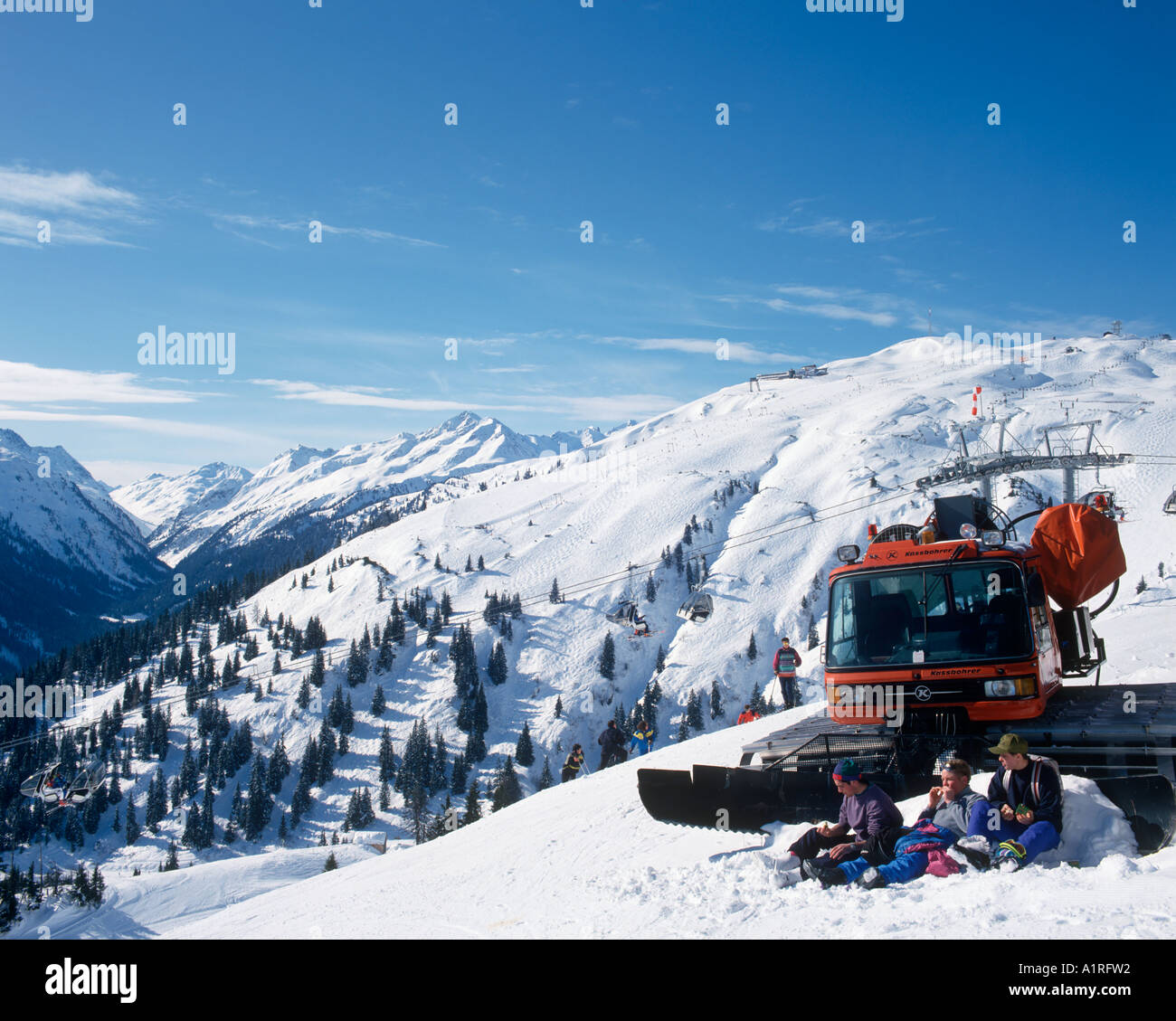 Skifahrer mit einem Picknick mit einer Pistenraupe, Skigebiet Gampen, St. Anton, Vorarlberg, Österreich Stockfoto