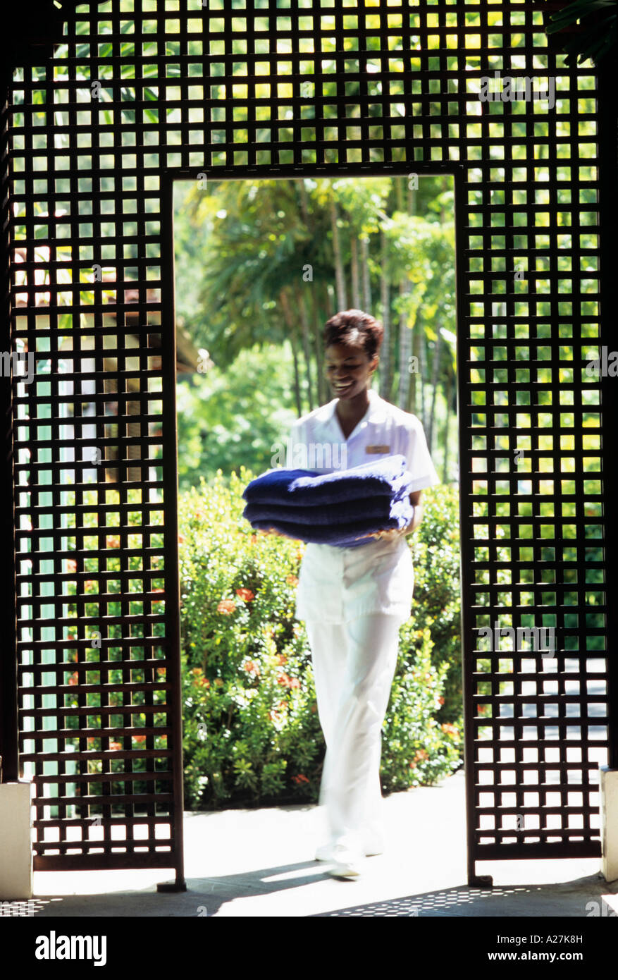 eine Kosmetikerin tragen frische Handtücher im Spa LaSource Hotel, Grenada Stockfoto