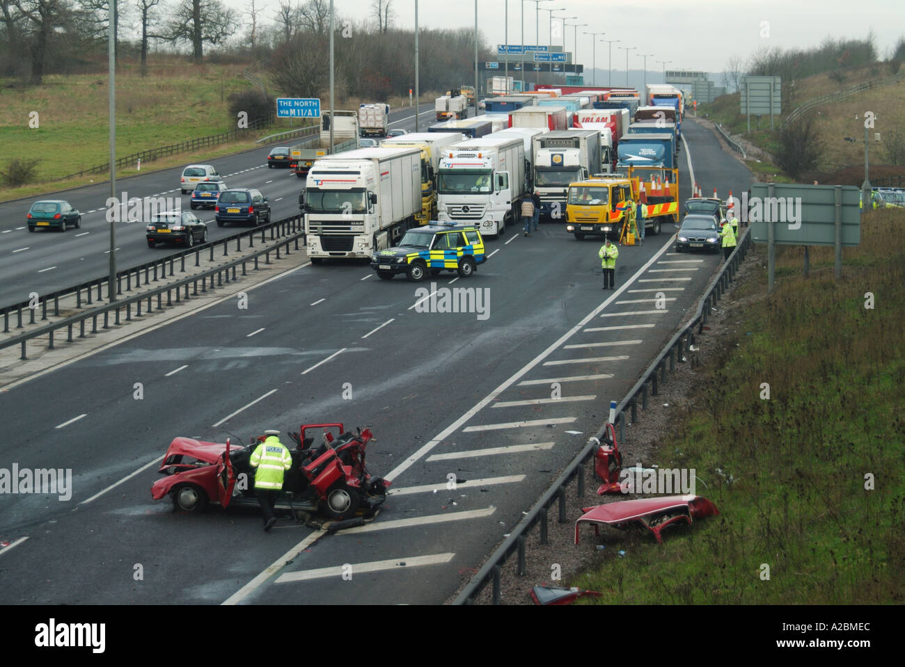 Luftaufnahme Polizei & Unfall Ermittler bei der Arbeit mehrere Stunden nach schweren Absturz LKW Warteschlange hielt Polizeiautos M25 Autobahn Essex England Stockfoto