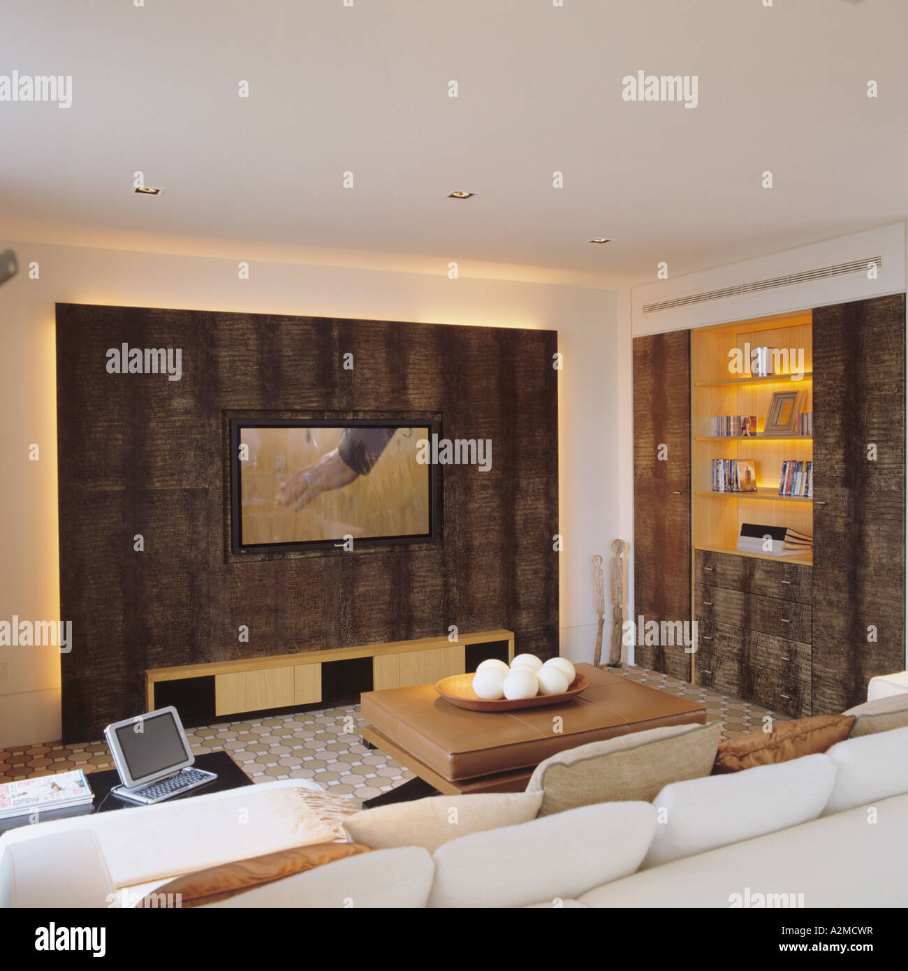 Wohnzimmer mit Flachbildschirm und Gold eingelassen Regal in Thames Penthouse-Wohnung, London Stockfoto