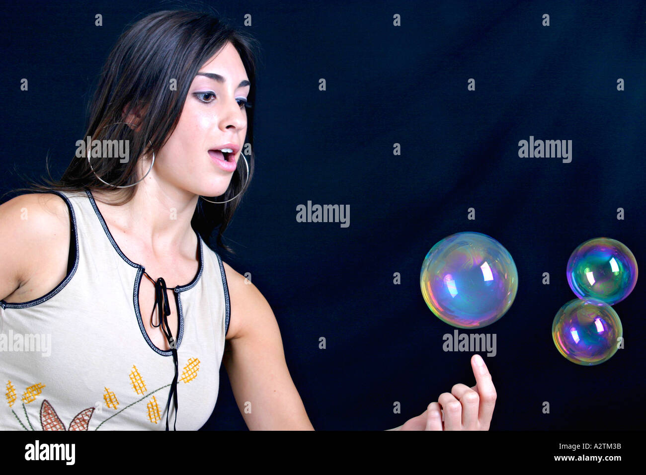Medium-Schuss von junge Frau spielt mit Seifenblasen verrauchten Stockfoto