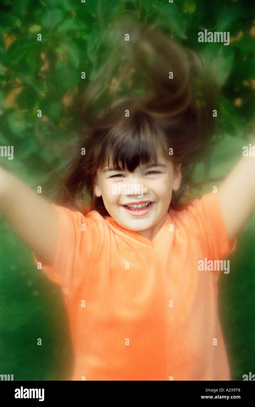 Lifestyle. Kinder. Garten. Nahaufnahme eines glücklichen Mädchens, das in einem Garten springt. Stockfoto