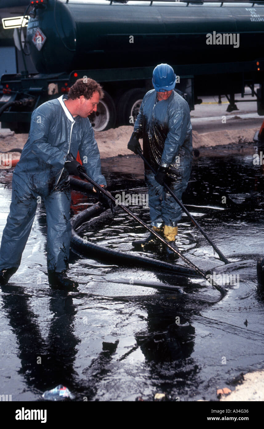 Arbeiter aufzuräumen und enthalten eine Ölkatastrophe in Long Island City-Queens eine Grundleitung führt aus einer Raffinerie in einem Vorratstank geplatzten Überflutung der Straße und einem kleinen Park mit Öl Stockfoto