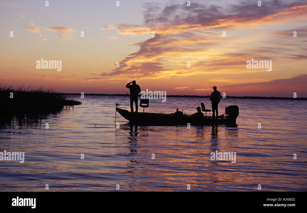 Fischer grüßen den Sonnenaufgang am See Weohyakapka in Polk County in Florida Stockfoto
