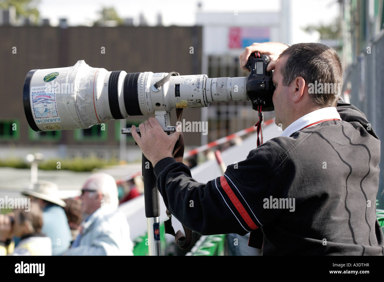 SPORT-FOTOGRAF MIT EINEM LANGEN CANON TELE-OBJEKTIV FOTOGRAFIEREN EIN CRICKET-MATCH BEI SOPHIA GÄRTEN, CARDIFF, SÜDWALES, GROßBRITANNIEN Stockfoto