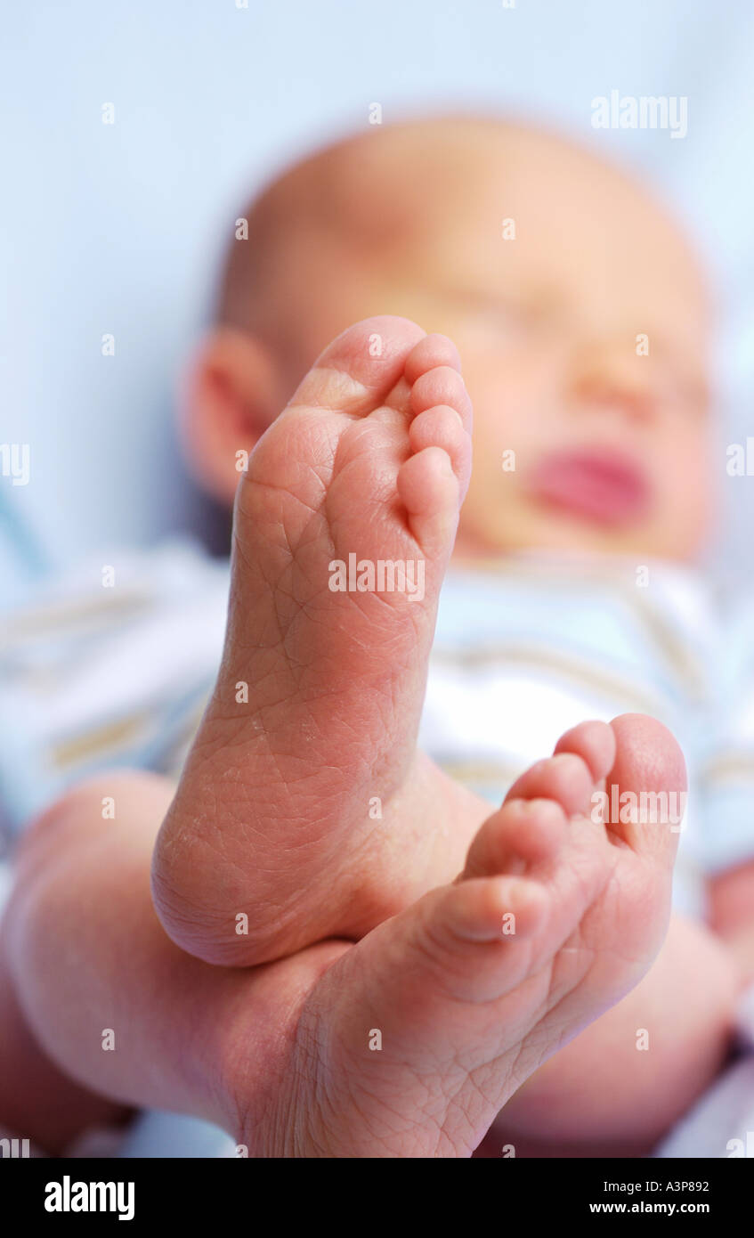Neugeborene schlafen mit Füßen im Vordergrund Stockfoto