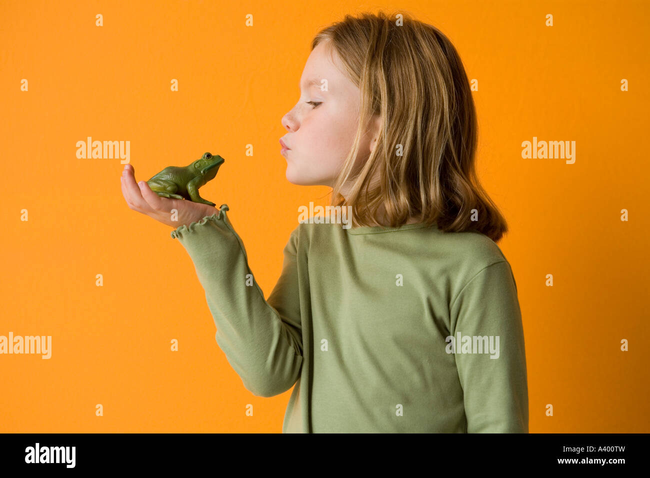 kleines Mädchen einen Frosch küssen Stockfoto