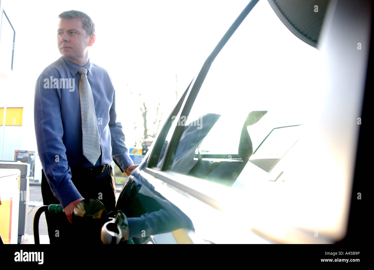 Lizenzfreie kostenlose Foto der britische Geschäftsmann füllt sich mit Benzin seinen Dienstwagen an einer Tankstelle London UK Stockfoto