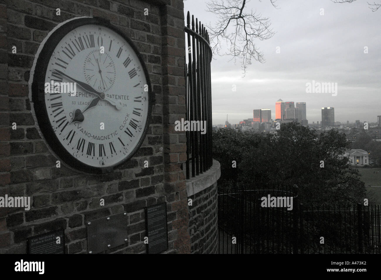 Dieses Bild ist der offizielle Royal Observatory Uhr in Greenwich und die Innenstadt von London im Hintergrund bei Sonnenuntergang. Stockfoto