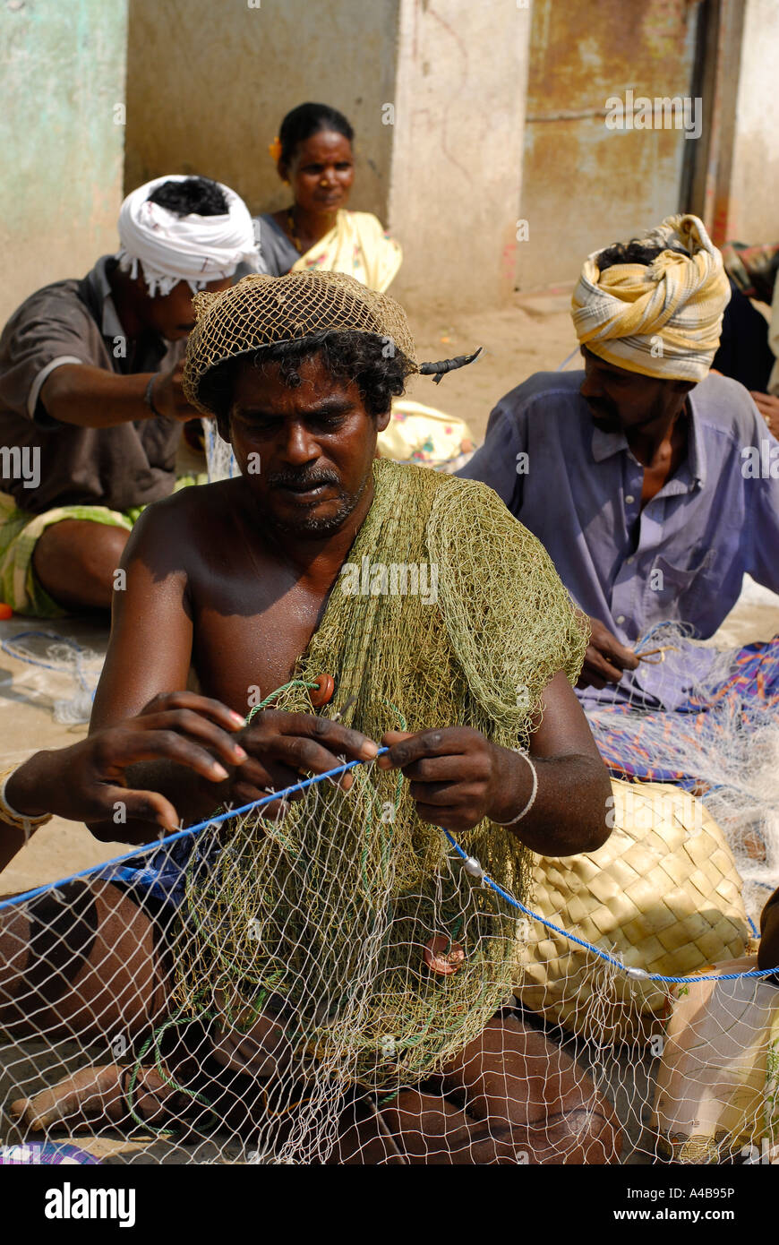 Abbildung des indischen Stammes-Fischer Fischer reparieren ihre Netze in der Nähe von Chennai Tamil Nadu, Indien Stockfoto