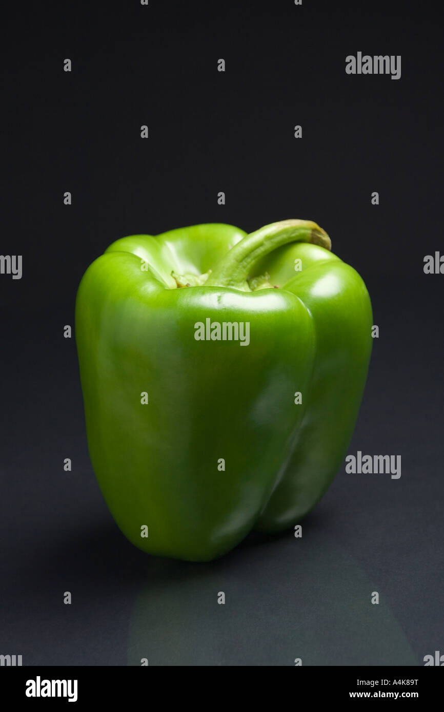 Grüne Paprika auf einem dunklen reflektierenden Hintergrund Stockfoto