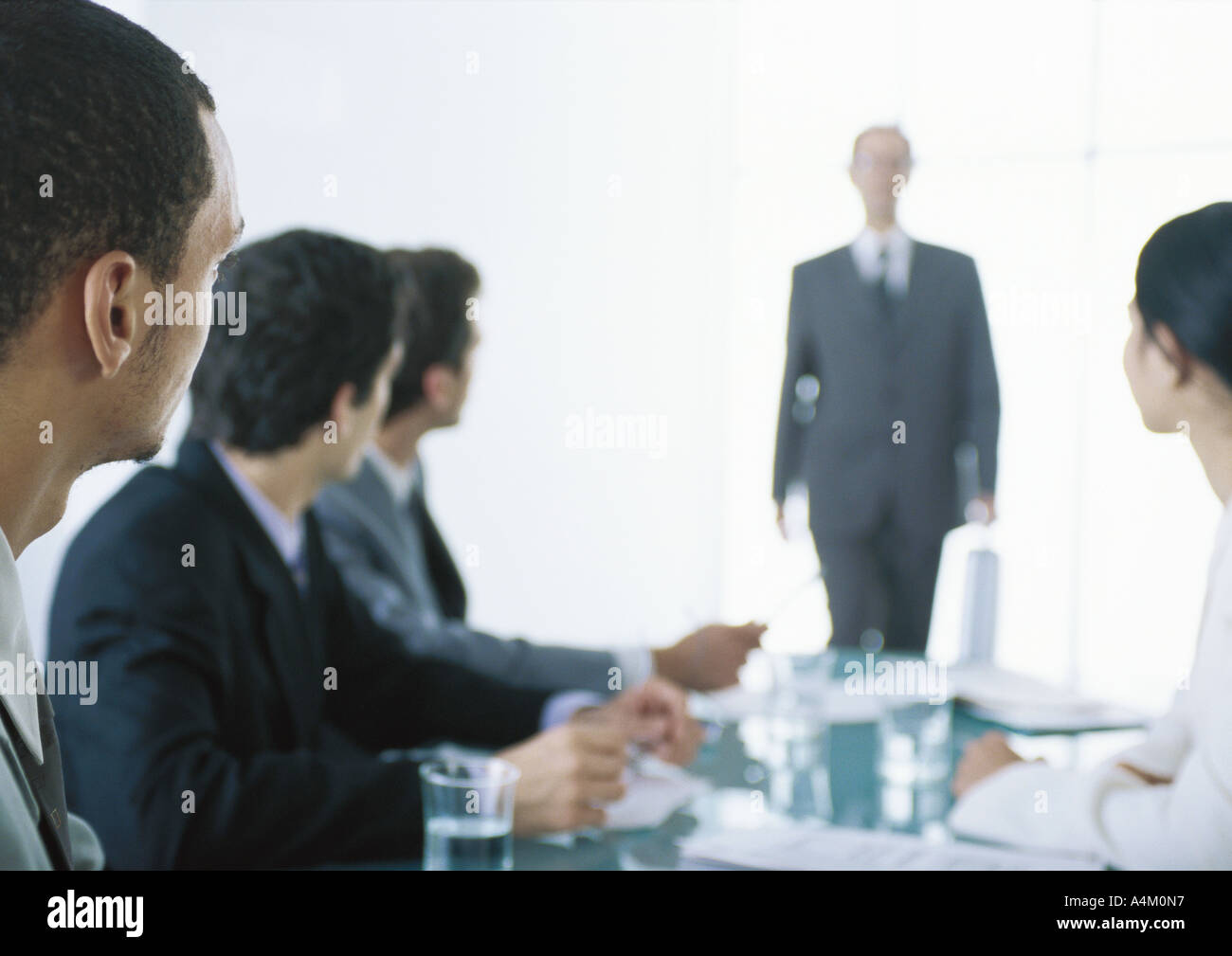 Geschäftsleute mit Kopf drehte sich zu Hintergrundbeleuchtung Geschäftsmann im Hintergrund am Tisch sitzen Stockfoto