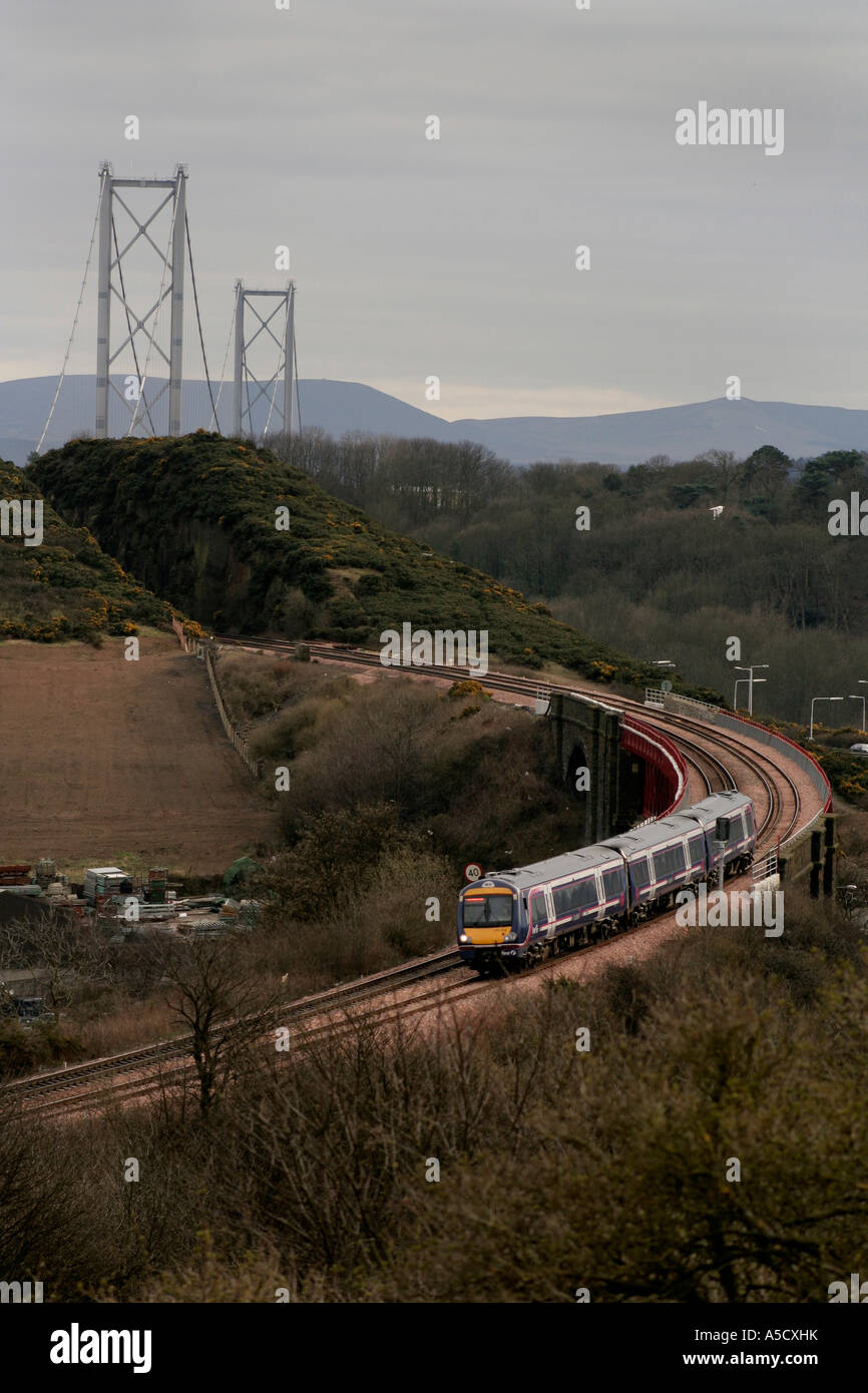 ScotRail Pendler-Zug von Edinburgh in Inverkeithing mit Forth Bridge im Hintergrund Stockfoto