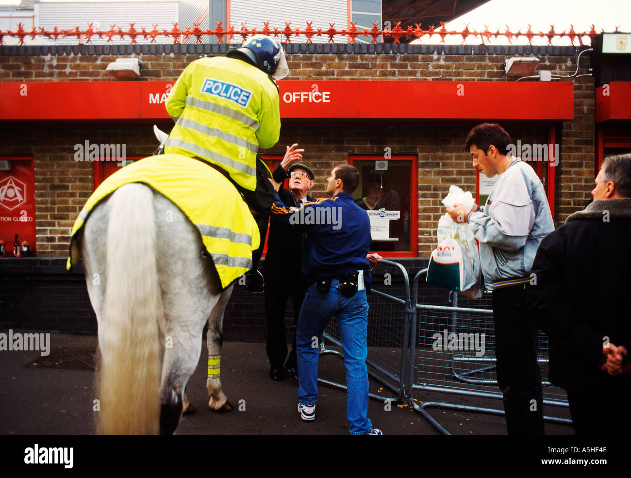 Einen montierten Polizei sprechen Sie mit einem alten Mann Stockfoto