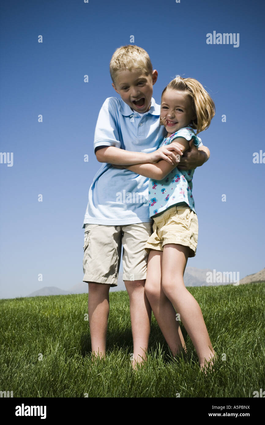 Jungen und Mädchen spielen auf einem Hügel Stockfoto