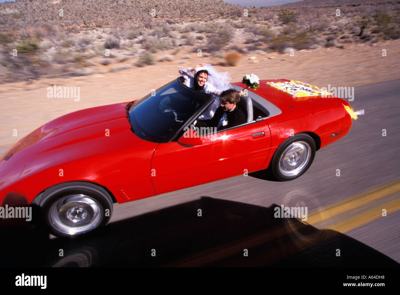 Braut und Bräutigam Fahrt durch die Wüste Red Rocks Highway in der Nähe von Las Vegas Nevada, USA Stockfoto