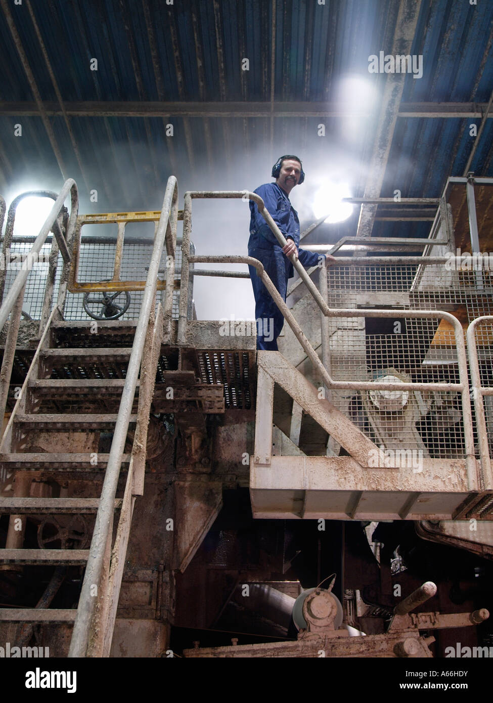 Papier Fabrikarbeiter steht auf riesige Papierherstellung Maschine in Papier-recycling-Anlage in Cuijk die Niederlande Stockfoto