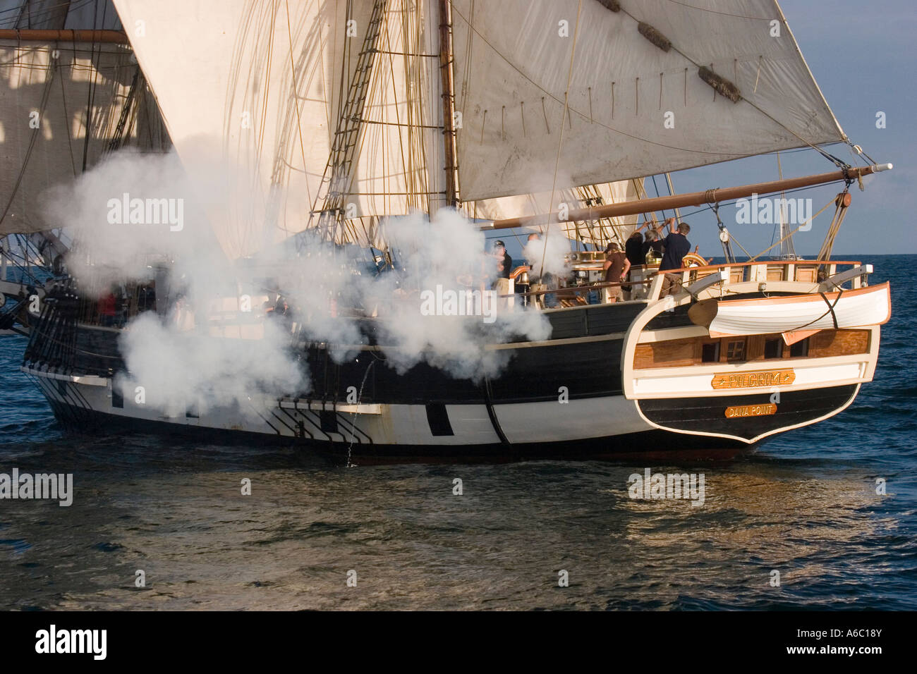 Rauchen Sie Wogen aus der Backbordseite des Brig "Pilgrim" in einem mock Feuergefecht während ein Festival der Segelschiffe in Dana Point, Kalifornien. Stockfoto