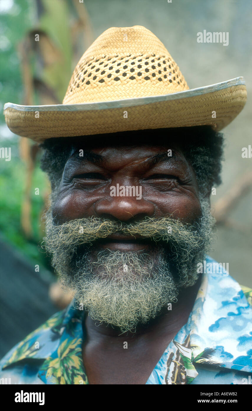 Porträt eines älteren Gärtners im städtischen Garten eines Kunden, der Bananen anstellt. Kingston. Jamaika Stockfoto