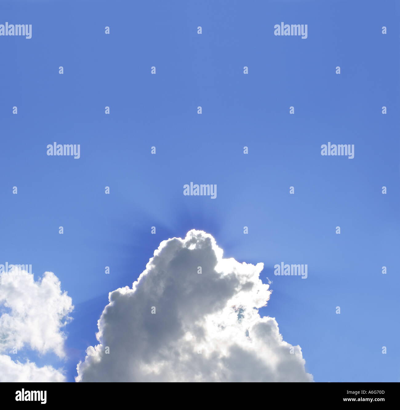 Sonne hinter Wolken am blauen Himmel Stockfoto