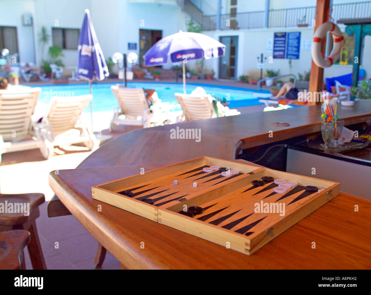 SPIEL VON BACKGAMMON AUF EINE BAR MIT POOL IM HINTERGRUND Stockfoto